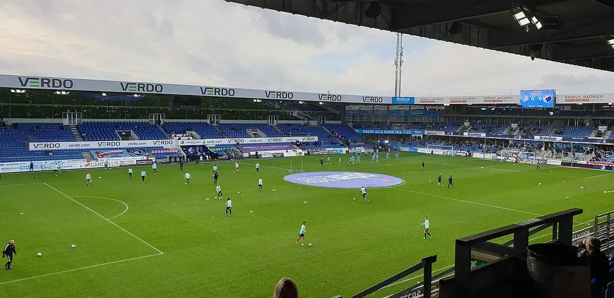 FC Copenhagen players warming up on a football pitch before a match.